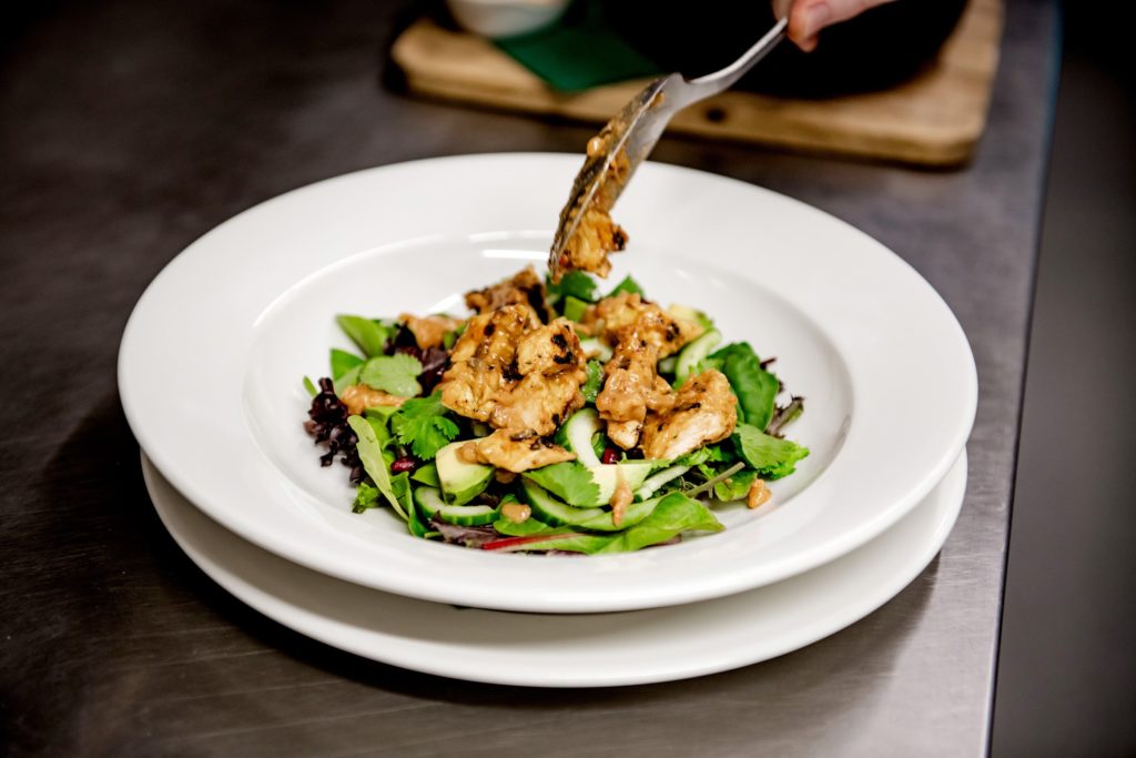 A plate of freshly cooked and prepared food, served on a bed of salad at the Ragged Trousers brasserie and pub in Tunbridge Wells