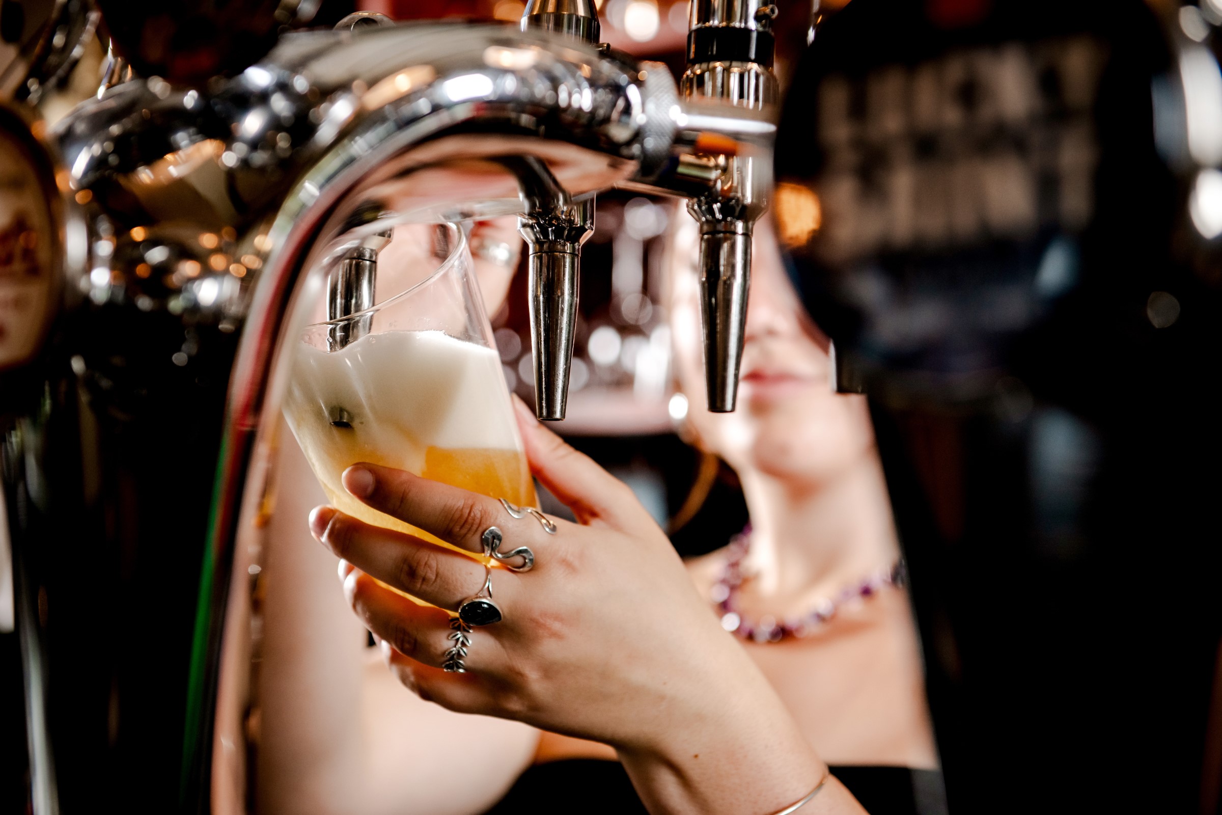 Bar worker pulling a pint of craft beer at the Ragged Trousers bar in Tunbridge Wells
