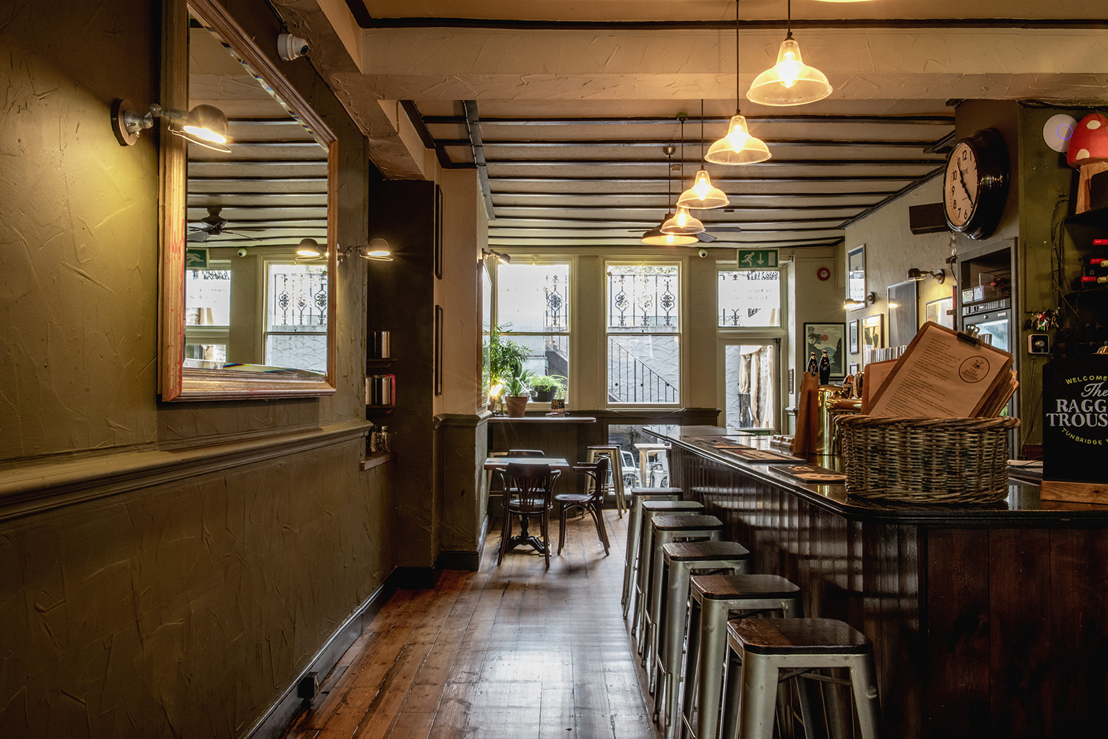 Clean, wooden bar and nearly arranged barstools at the ragged trousers pub in Tunbridge Wells