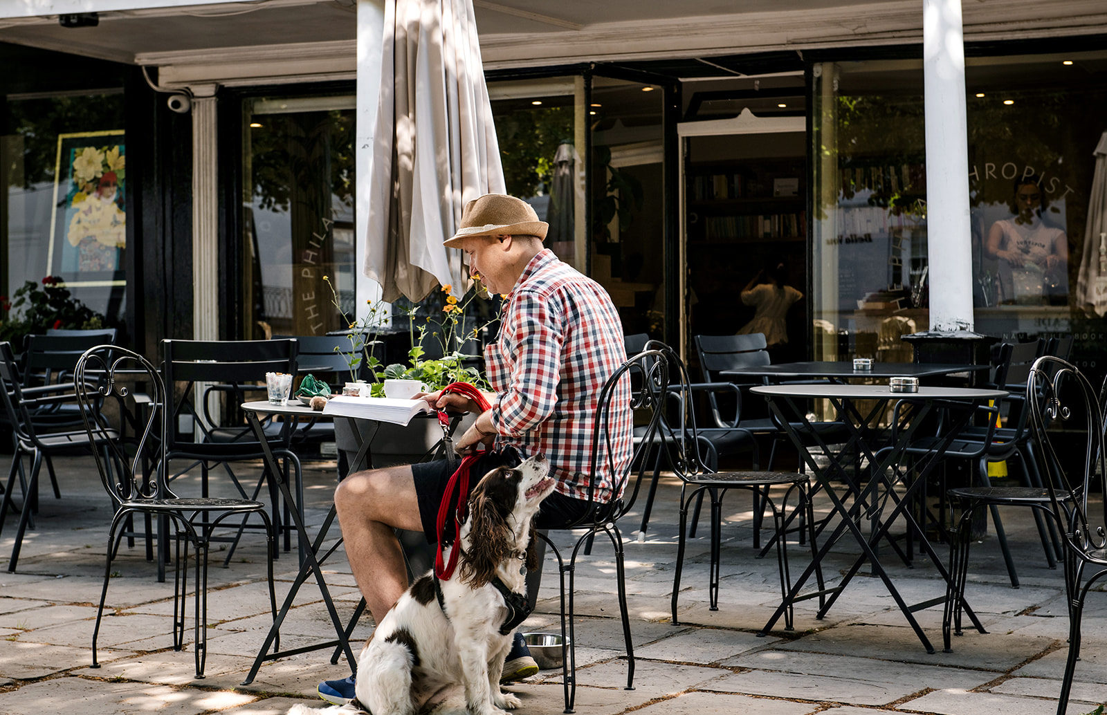 A man sitting outside the Philanthropist cafe in The Pantiles Tunbridge Wells