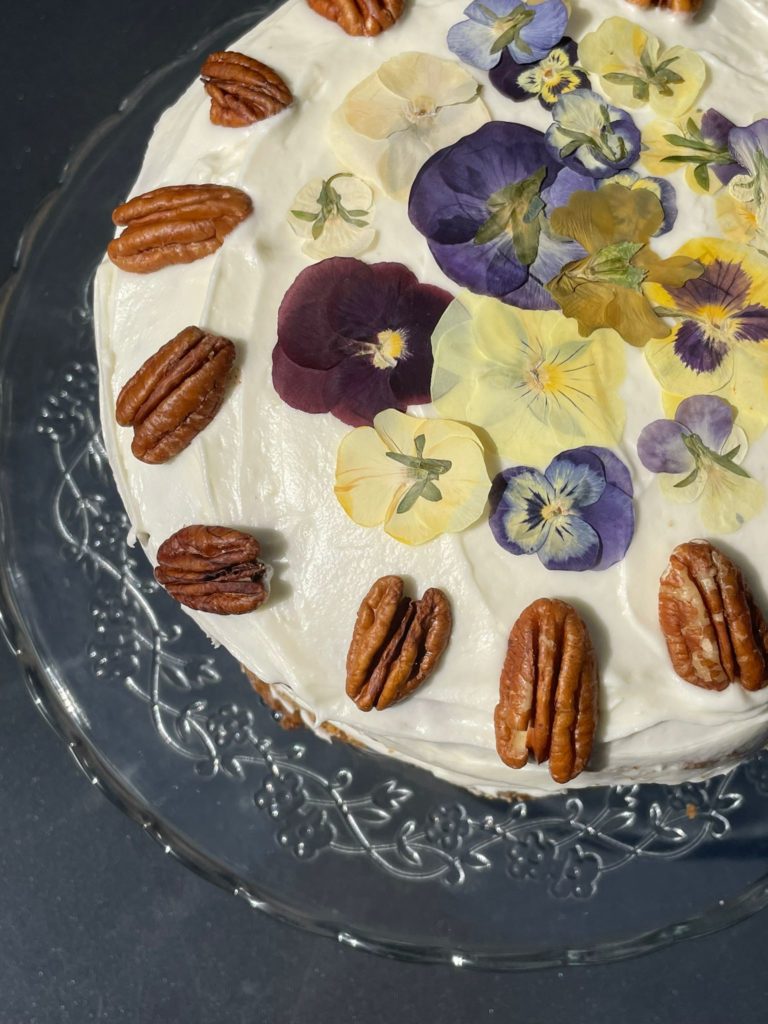 Handmade cake with flower petals and pecans, served at The Philanthropist Coffee Shop in Tunbridge Wells