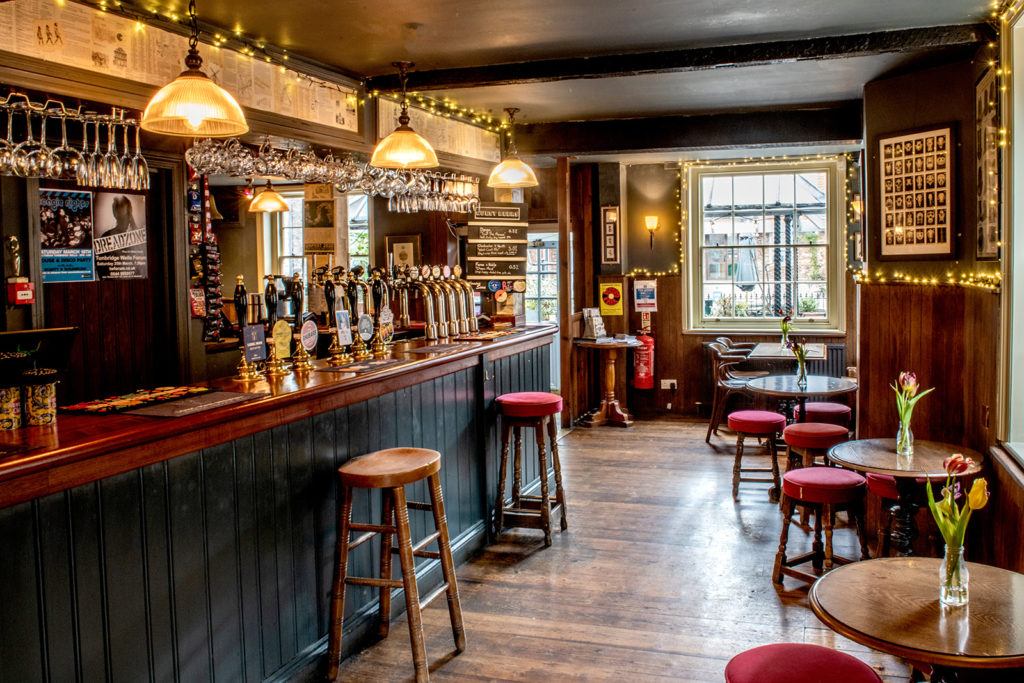 traditional pub interior with bar stools and warm decor