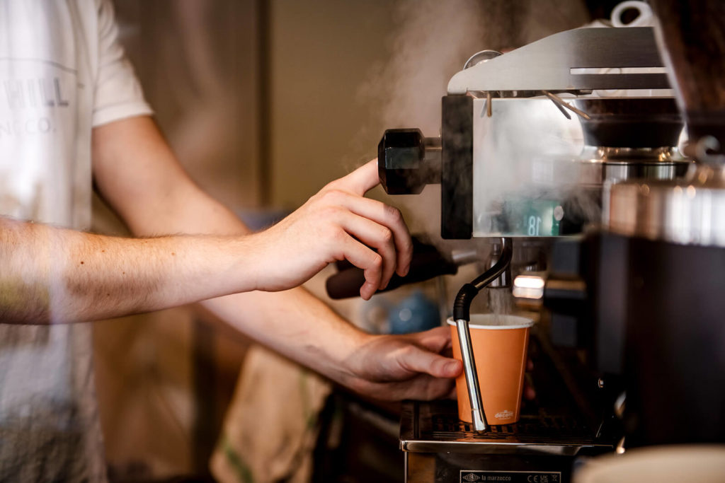 A barista pours coffee in The Philanthropist cafe in the Pantiles Tunbridge Wells